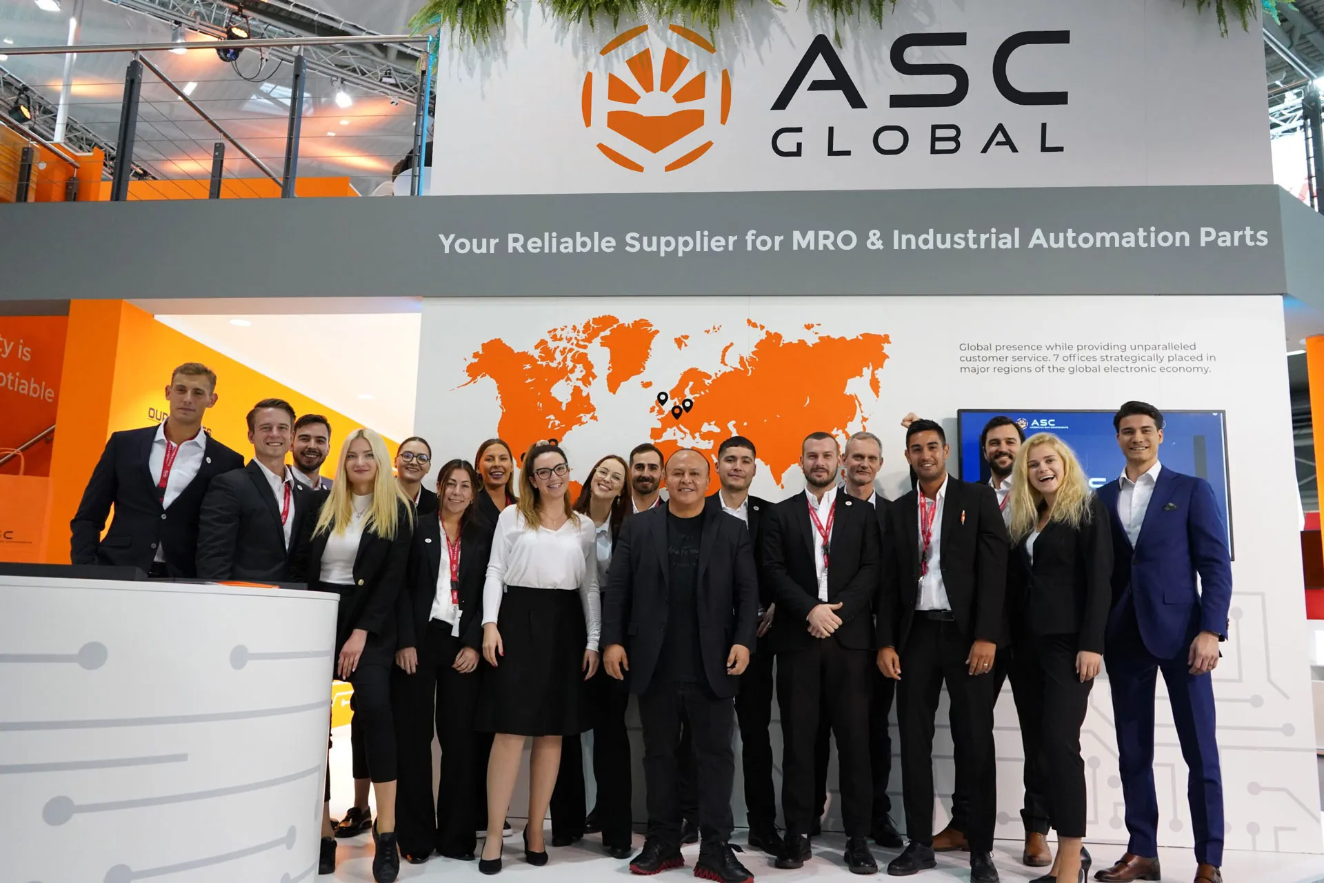 Image of ASC Global's two-floor booth at Electronica 2024, featuring the ASC Global team promoting services such as Global Shortage Sourcing, Vendor Managed Inventory, Franchised Distribution, Manufacturing, Rebate Programs, and Excess Inventory Management.