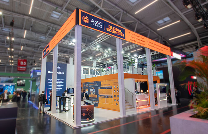 asc_global_booth_electronica_2024_01 Image of ASC Global's two-story booth displayed at the Electronica 2024 trade show, featuring a modern design showcasing their services and capabilities in the electronic components industry
