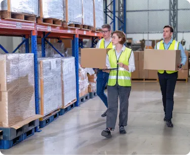 industrial_warehouse_img_02 Photo of workers carrying boxes and using a tablet representing ASC Global’s strategic data feedback, providing detailed asset insights to help prevent future excess through data-driven forecasting.
